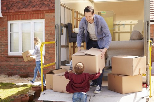 Furniture removal team handling a sofa move in Queens Park