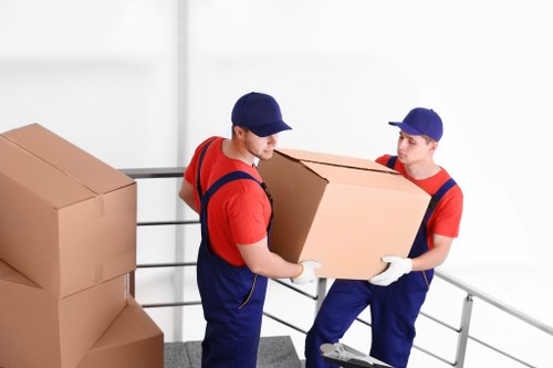 Careful loading of household furniture for transport in Queens Park