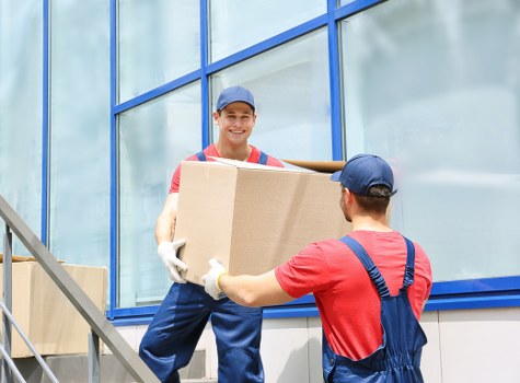 Heavy furniture being moved safely through a residential property in Queens Park