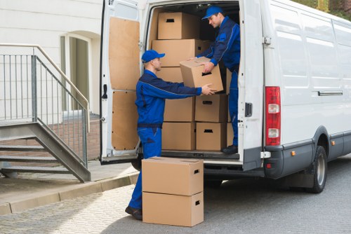 Removal van and movers preparing for a house move in Queens Park