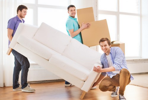 Moving boxes and furniture being loaded into a hire truck