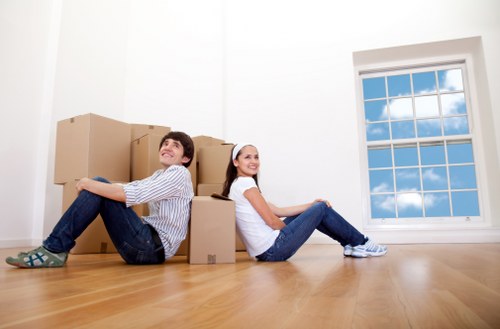 Professional mover transporting furniture for a Queens Park customer