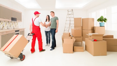 Bulky household furniture being loaded for pick-up near Queens Park