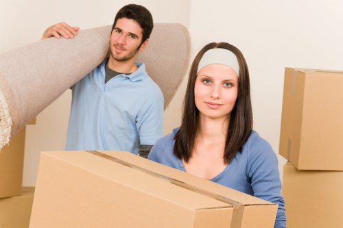 Local moving team packing furniture and household belongings in Queens Park
