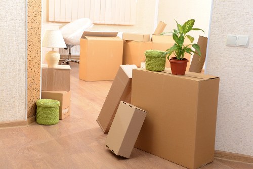 Professional movers handling furniture in a Queens Park flat